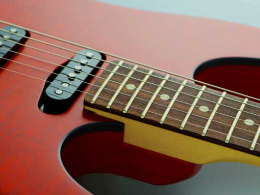 Black bound Silky Oak veneer top on Ash body.